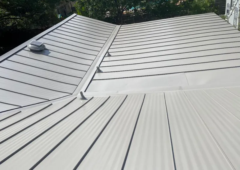 Solar attic fan installed on a metal roof for Roof Ventilation in Briarcliff Manor